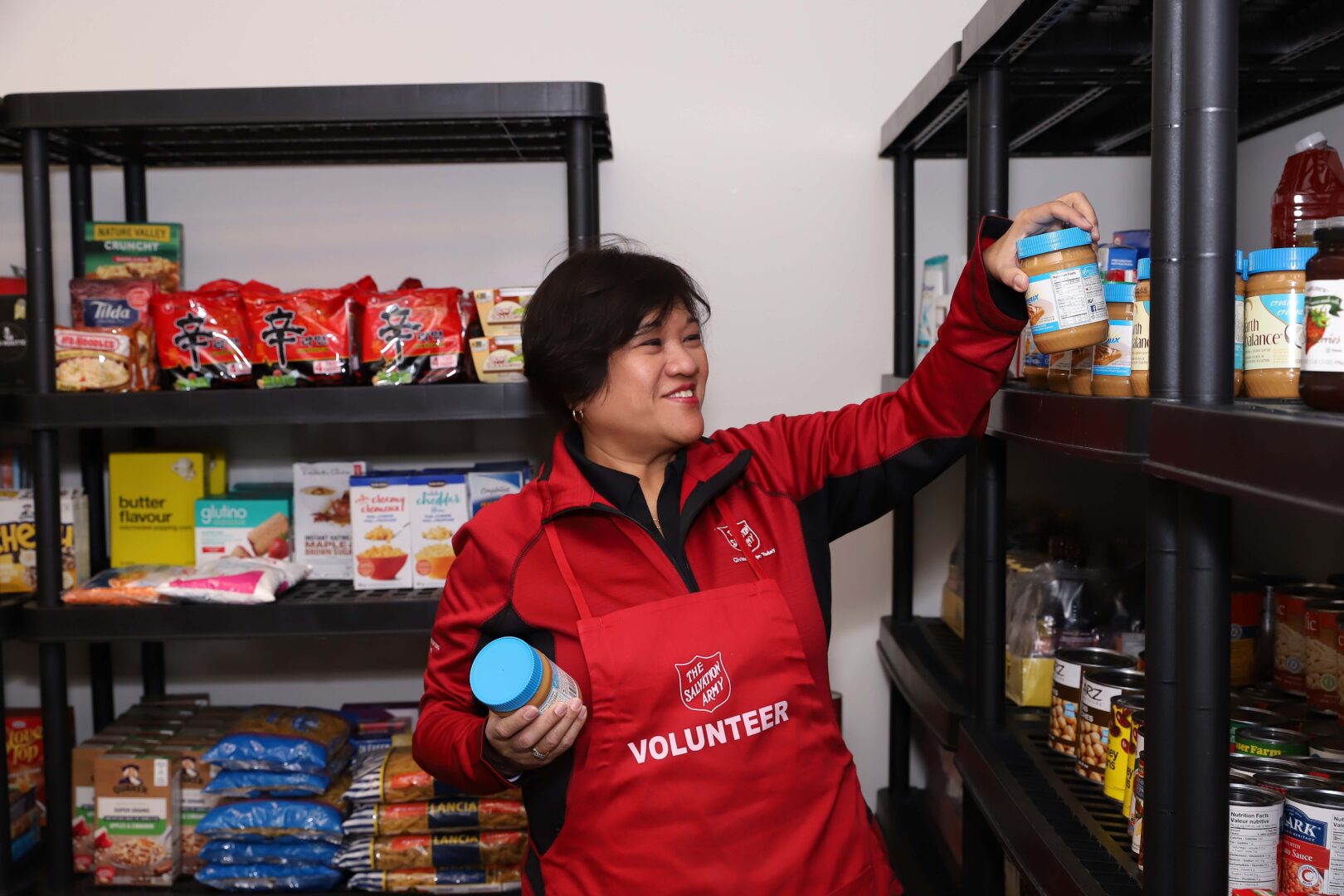 Salvation Army volunteer sorting food in a food bank