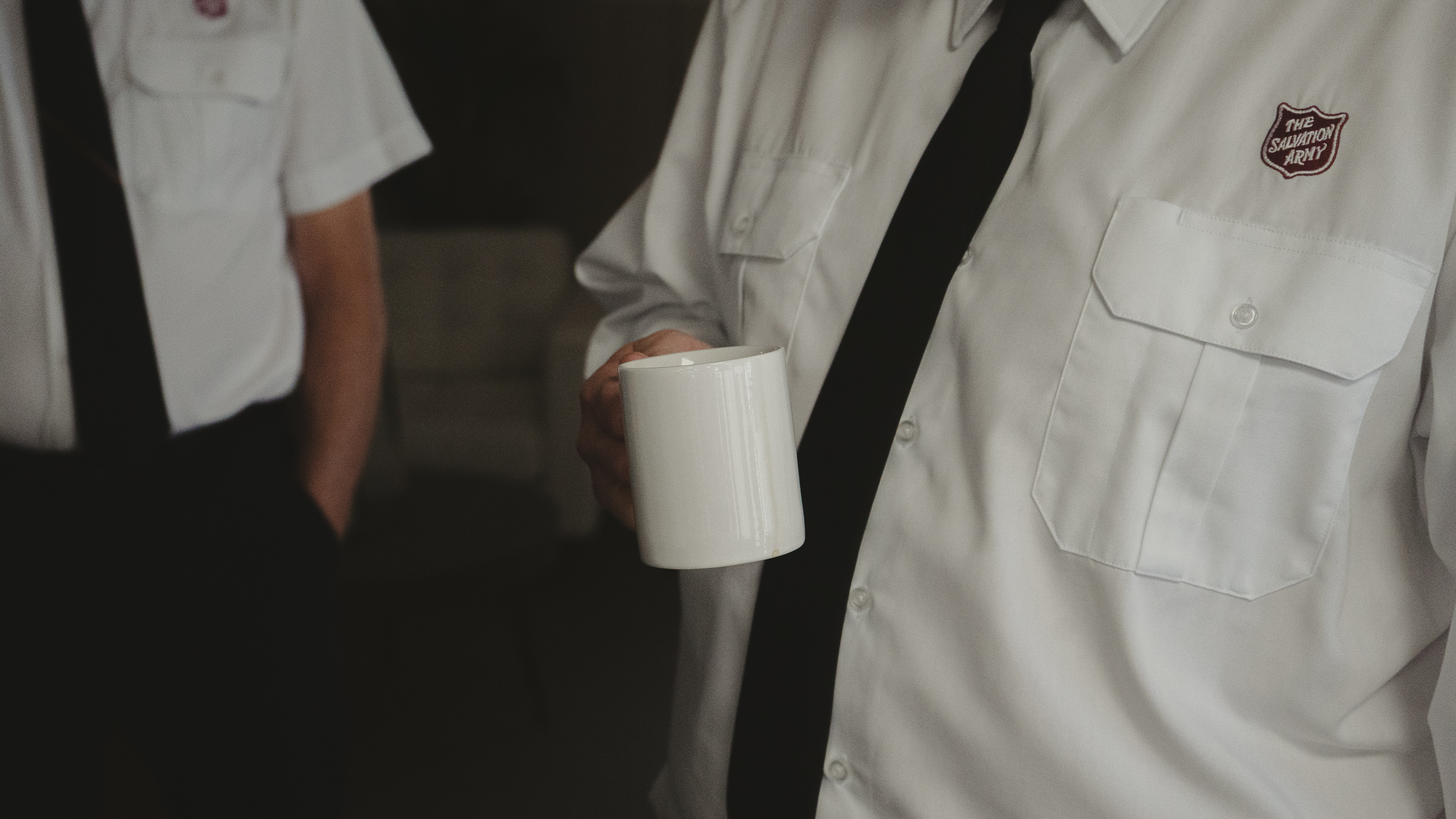 Salvation Army officer holding a mug
