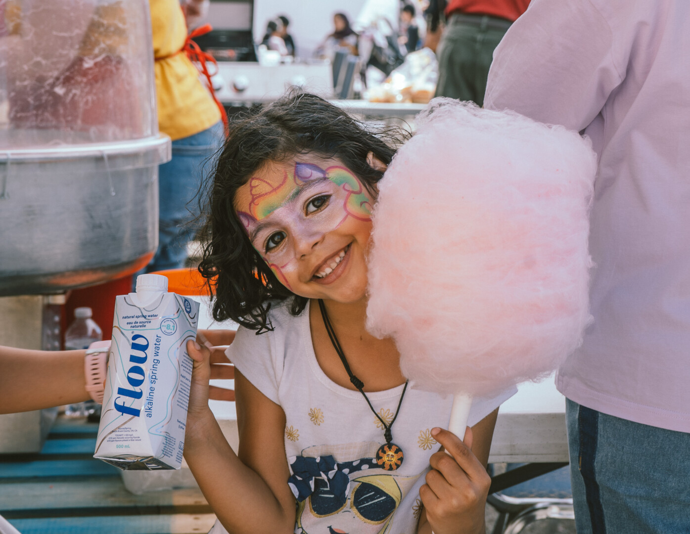 a girl holding ding candy floss