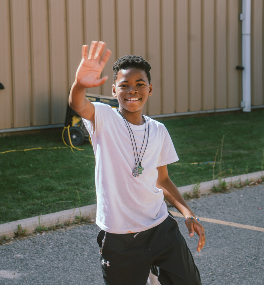 a boy waving
